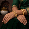 A set of antique-finish bangles with delicate floral engravings for women