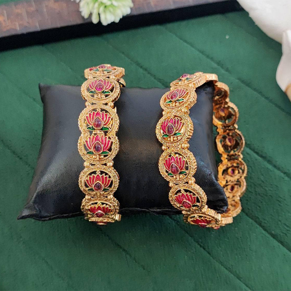 Antique gold bangle set featuring delicate lotus motifs.
