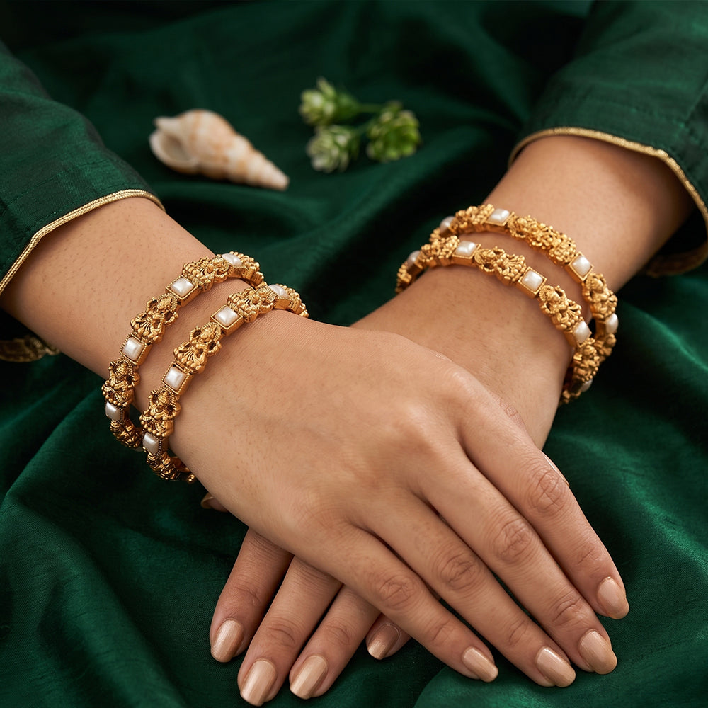Traditional temple style Lakshmi gold bangles with pearl embellishments