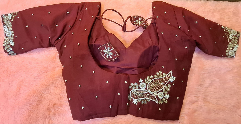 Maroon silk readymade blouse featuring detailed hand embroidery and pearl embellishments.