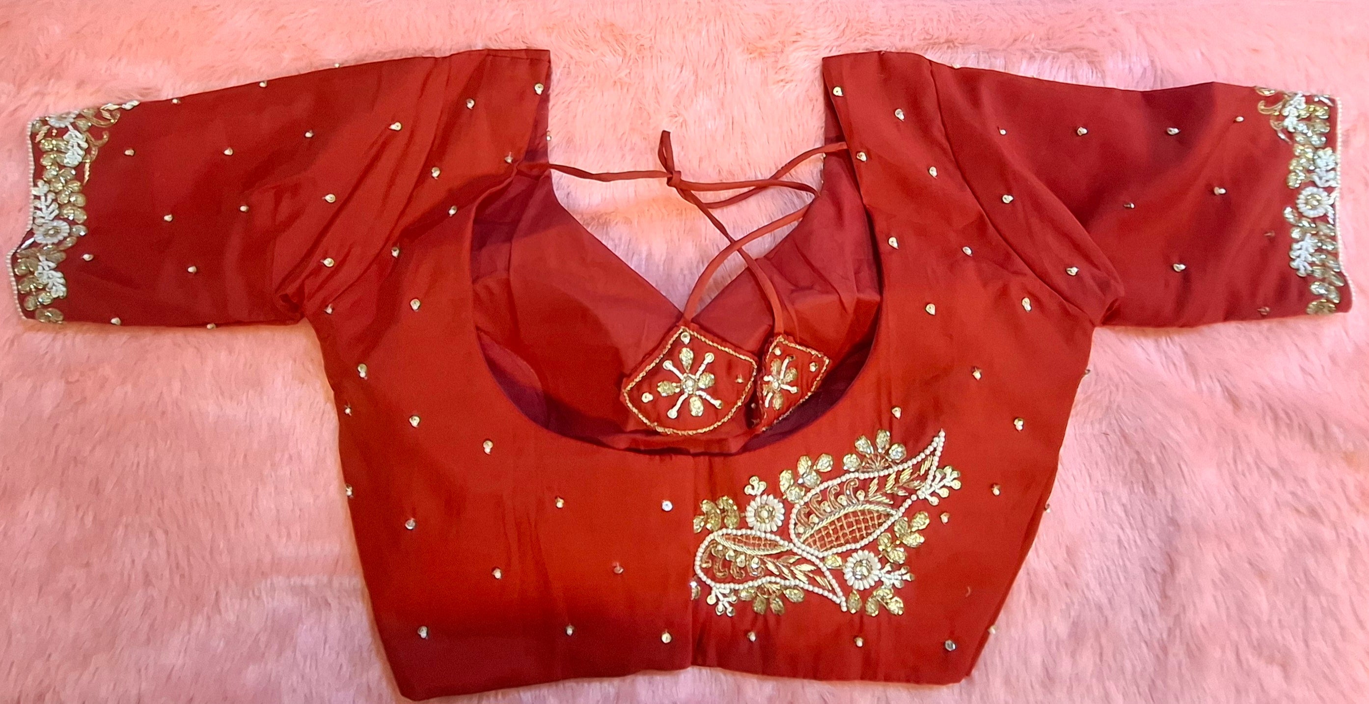Red silk readymade blouse with intricate hand embroidery and zardosi detailing.