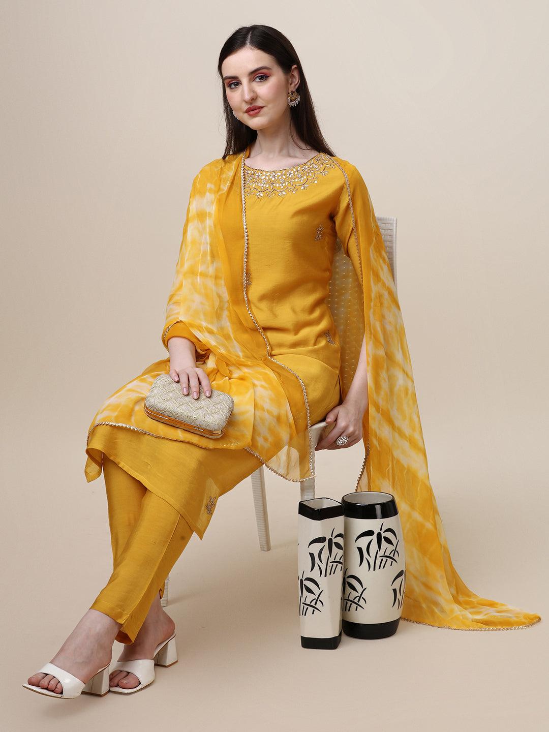 Model wearing a multicolor rayon thread embroidered kurta with matching pant and dupatta set
