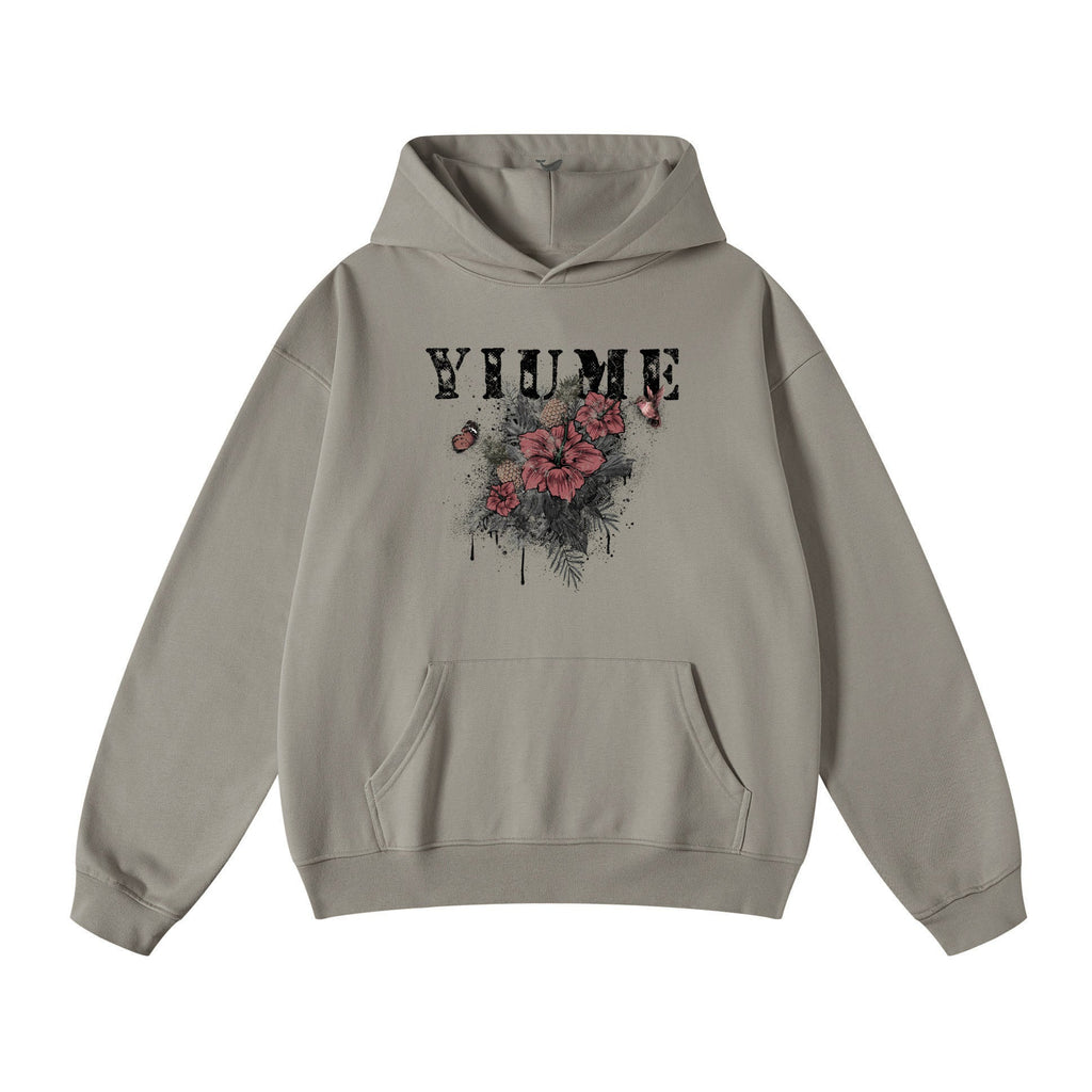 Men wearing a hibiscus blossom print knit hoodie in grey, red, and black colorways