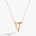 White pearl bead necklace with a gold-plated bow and crystal centerpiece on a rosary chain