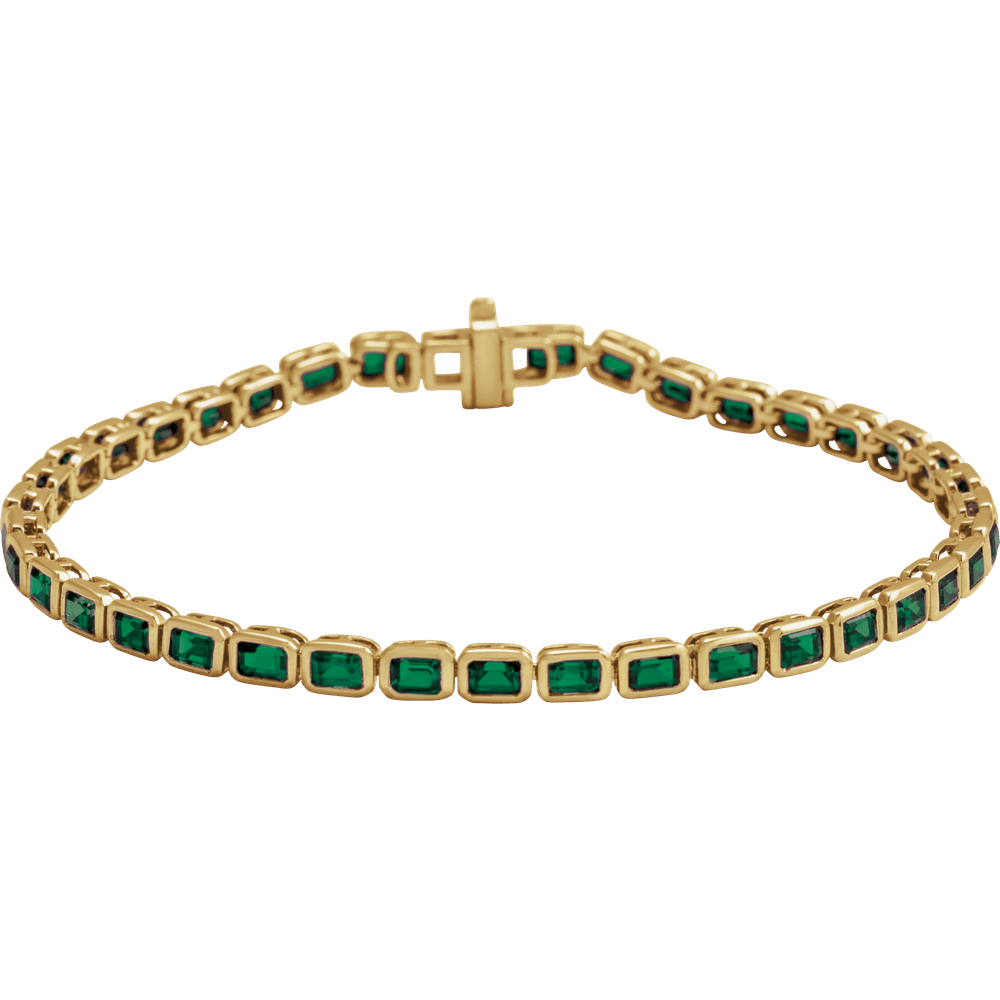 14K yellow gold bracelet featuring a row of emerald-cut natural tsavorite garnet stones.
