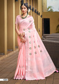 A toddler wearing a elegant baby pink linen-cotton saree with gold zari weaving detail.