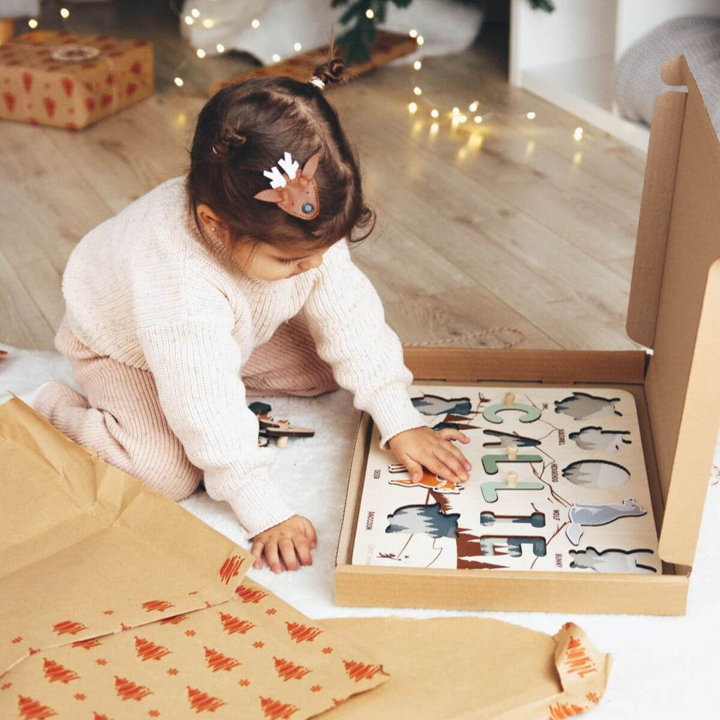 Personalized woodland-themed wooden name puzzle for a baby's first Christmas gift
