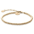 Close up of The Beaded Bracelet in 14K gold plated sterling silver on a neutral background.