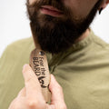 Handcrafted solid walnut wooden beard comb with smooth finish for thick facial hair.