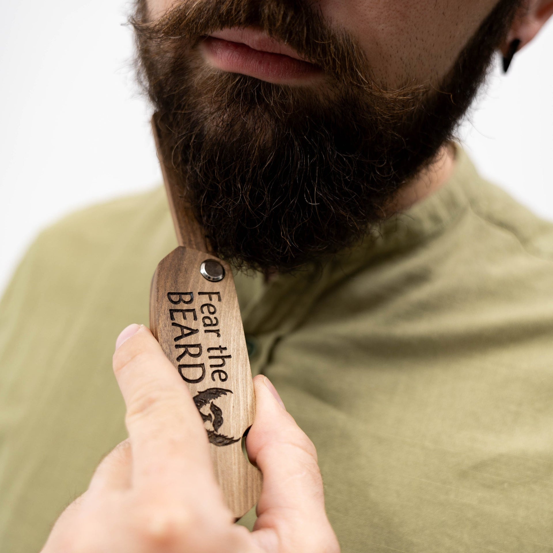 Handcrafted solid walnut wooden beard comb with smooth finish for thick facial hair.