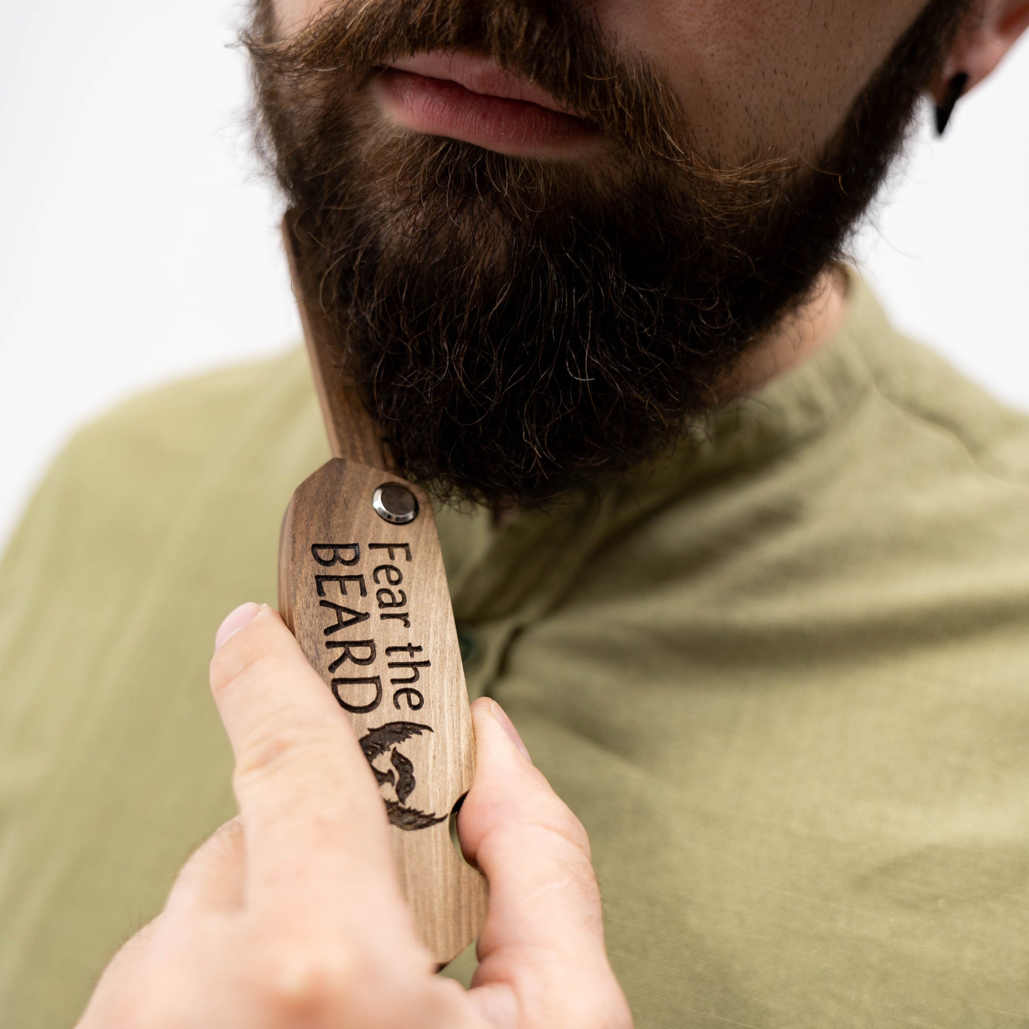 Handcrafted solid walnut wooden beard comb with smooth finish for thick facial hair.