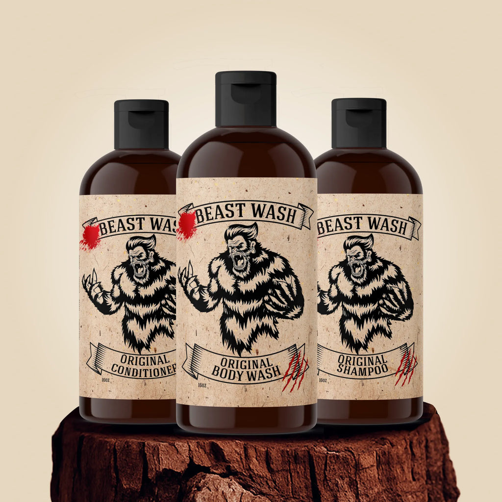 Johnny Slicks Beast Wash shower set featuring bottles of organic shampoo, body wash, and conditioner on a tree stump.