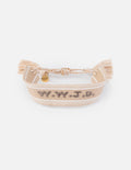 Beige woven fabric bracelet with What Would Jesus Do embroidered text in a minimalist style.