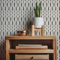 Blake geometric wallpaper in a modern black, white, and blush-pink color palette.