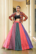 Woman wearing a vibrant multi-colored bohemian silk lehenga choli with traditional embroidery and polka dot print.