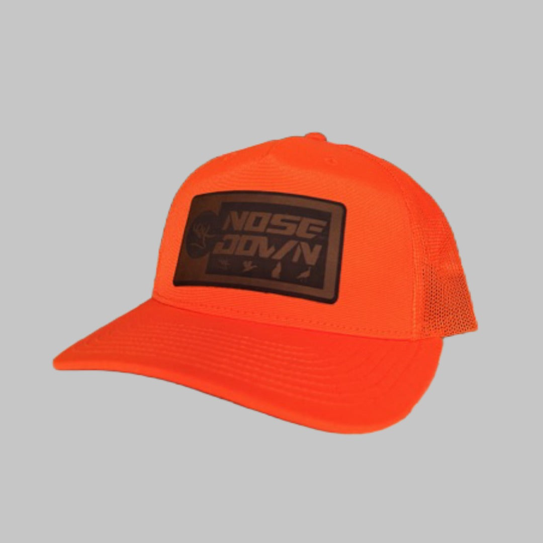 Red Man Trucker Hat featuring a unique leather outdoor-themed patch