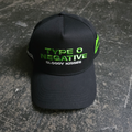 A black baseball-style cap with lime green embroidered Type O Negative and Bloody Kisses text on the front and a green kiss graphic on the side.