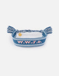 Blue woven fabric bracelet with What Would Jesus Do embroidered text.