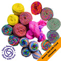 Bundle of vibrant recycled sari silk yarn featuring golden, teal, and coral colorways