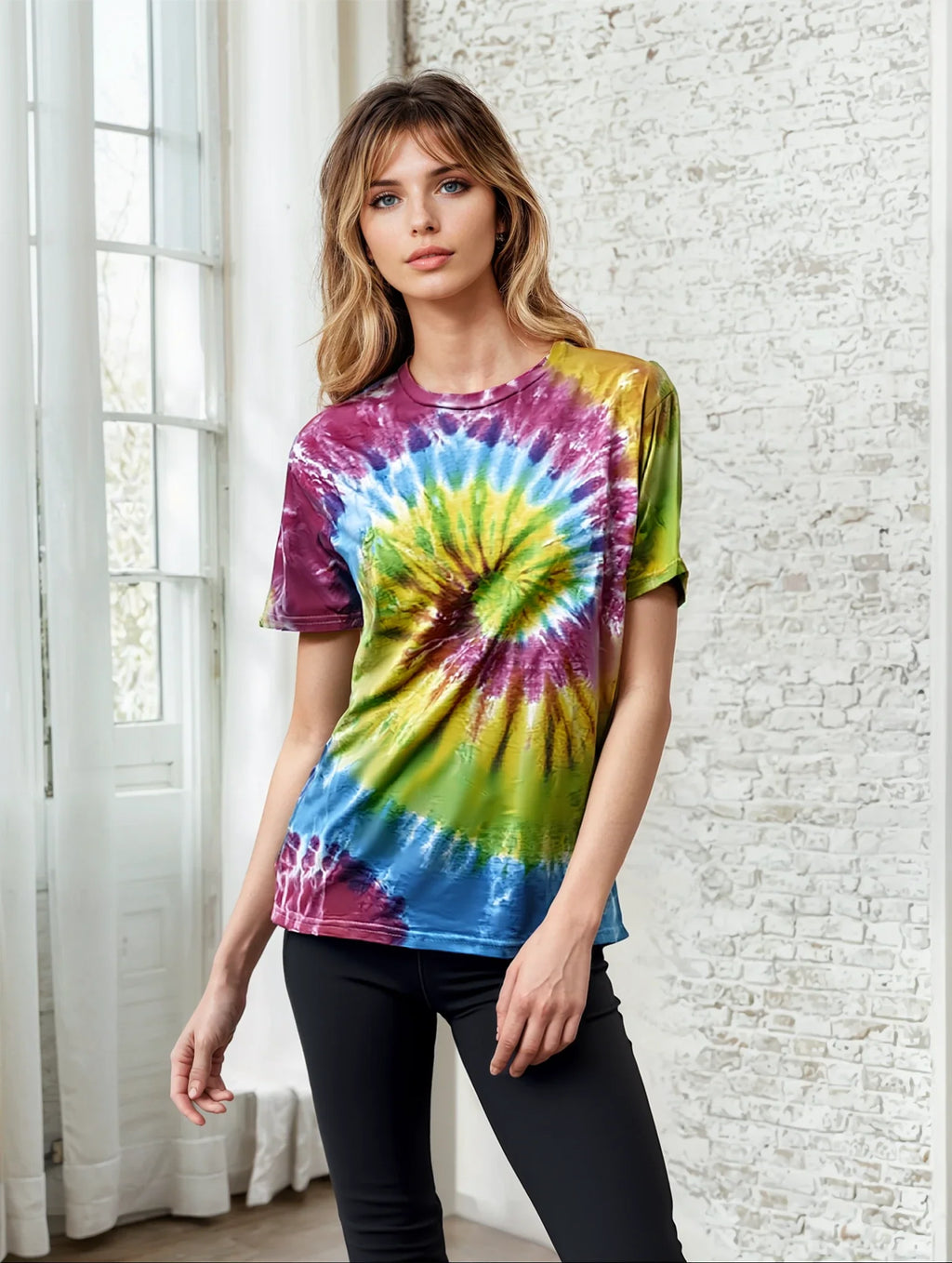 Model wearing a vibrant multi-colored spiral tie dye crew neck t-shirt.