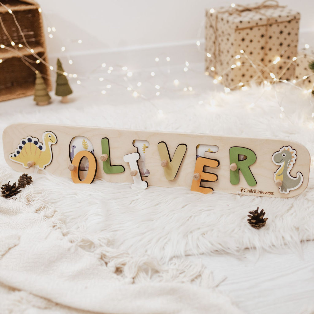 Neutral-toned dinosaur-shaped wooden name puzzle for children in beige, green, and yellow.