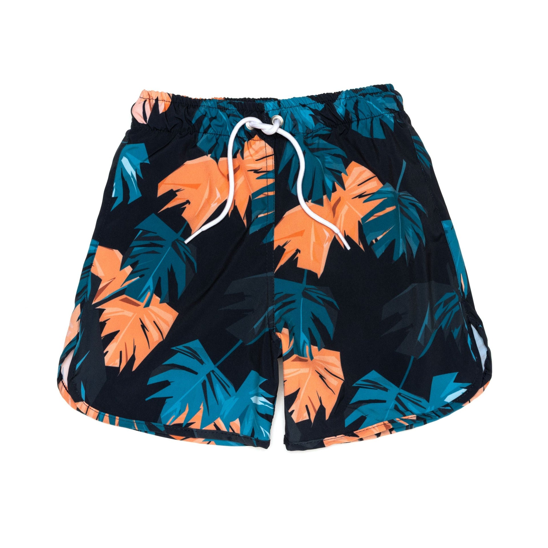 Boy wearing blue classic boardshorts with an elastic waistband at the beach.