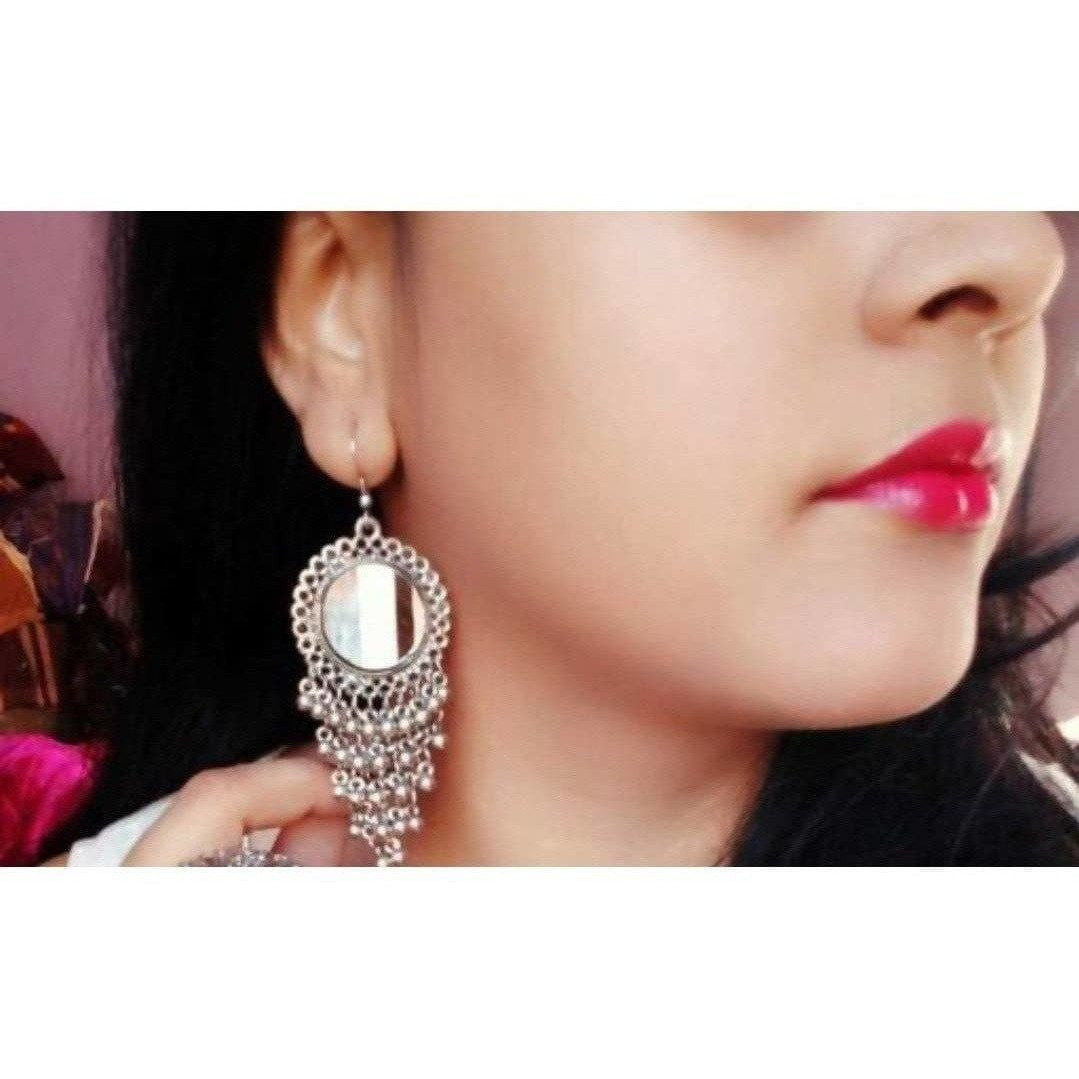 Antique silver oxidized sun design earrings with mirrors and small bells.