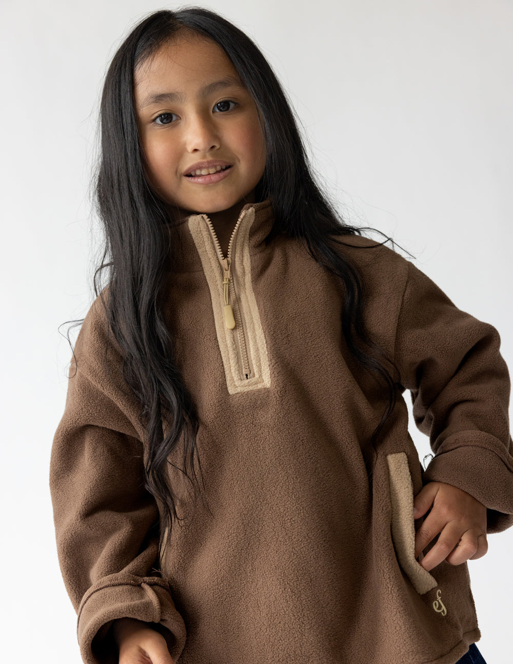A soft chestnut brown fleece kids pullover with a comfortable oversized fit.