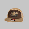A structured 7-panel Freezer Queen branded hat in a casual outdoor setting
