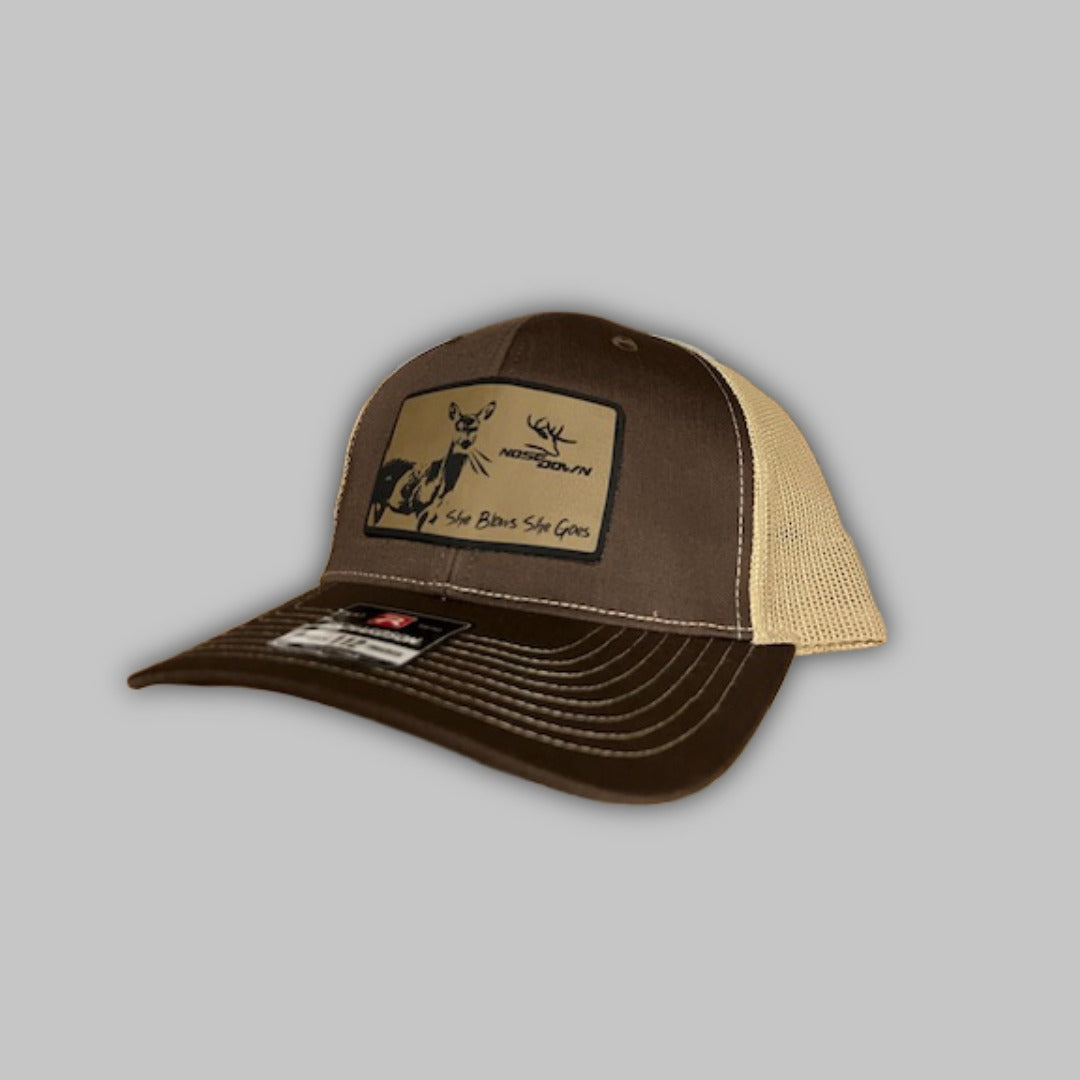 Unisex She Blows She Goes trucker hat in camo and tan with adjustable snapback closure