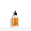 White and orange bottle of Bumble and bumble Tonic Lotion Primer, a medium weight pre-styler.