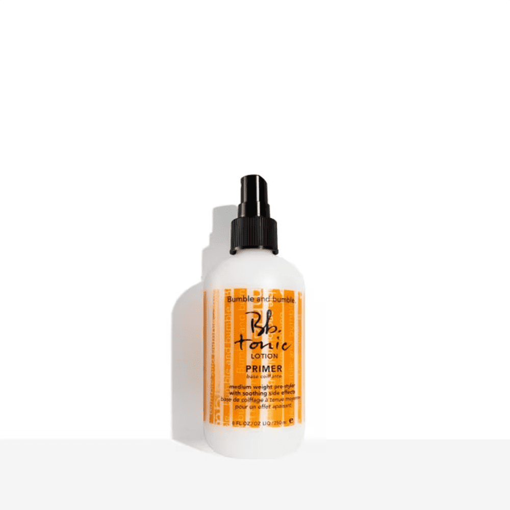White and orange bottle of Bumble and bumble Tonic Lotion Primer, a medium weight pre-styler.