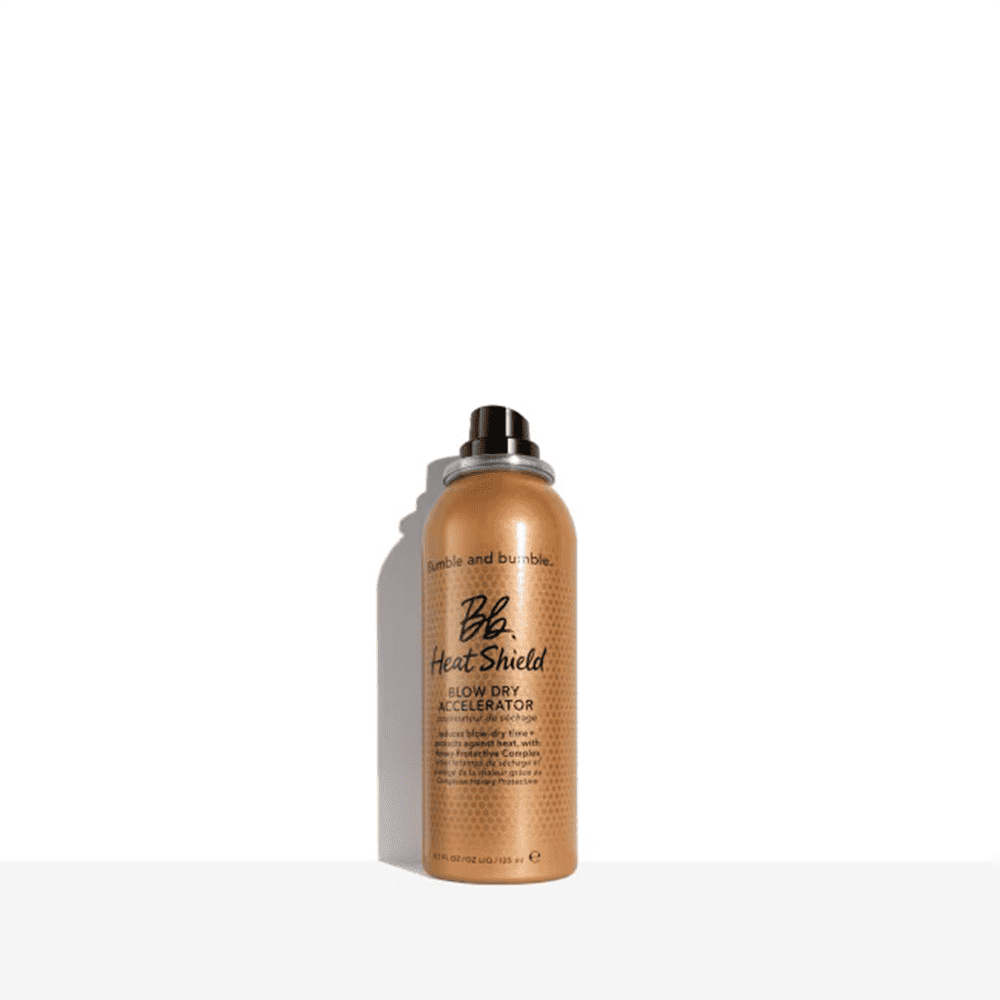 Bumble and bumble Heat Shield Blow Dry Accelerator 4.2 OZ spray in a metallic gold canister with black text.