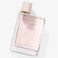 Burberry Her Eau de Parfum in a minimalist clear glass bottle with gold accents.
