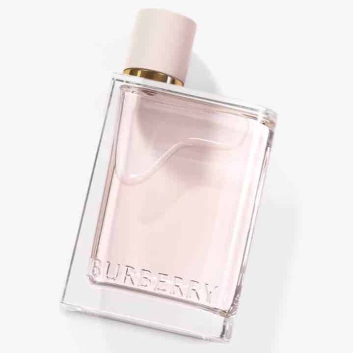 Burberry Her Eau de Parfum in a minimalist clear glass bottle with gold accents.