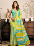 A woman wearing a vibrant yellow Leheriya linen ready-to-wear saree with a contrasting turquoise blouse.
