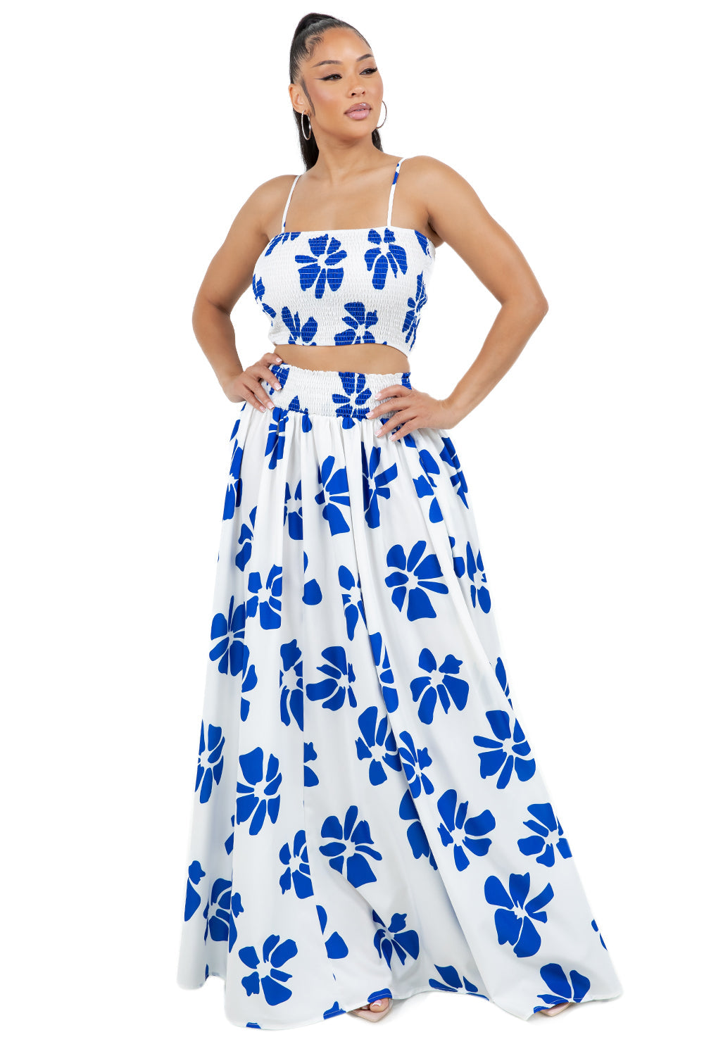Model wearing a matching two-piece top and skirt set by BY CLAUDE