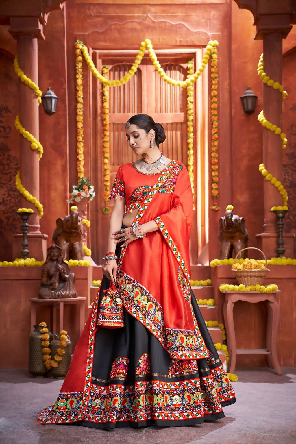 Black Art Silk lehenga with a vibrant red blouse and matching dupatta for Navratri.