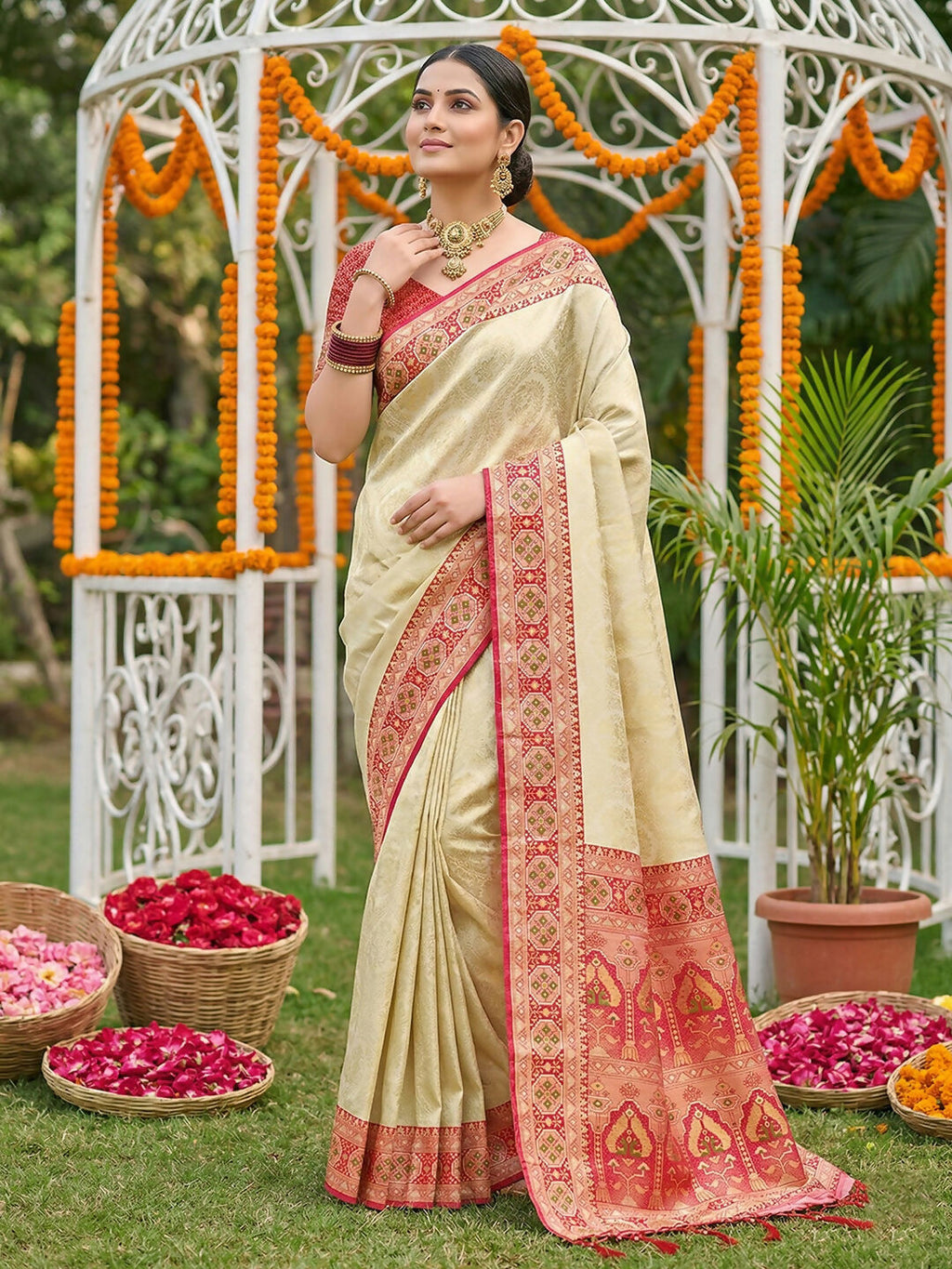 Model wearing a vibrant red soft silk saree with matching blouse piece