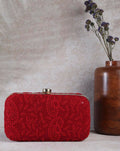Red embellished potli clutch for women featuring intricate detailing