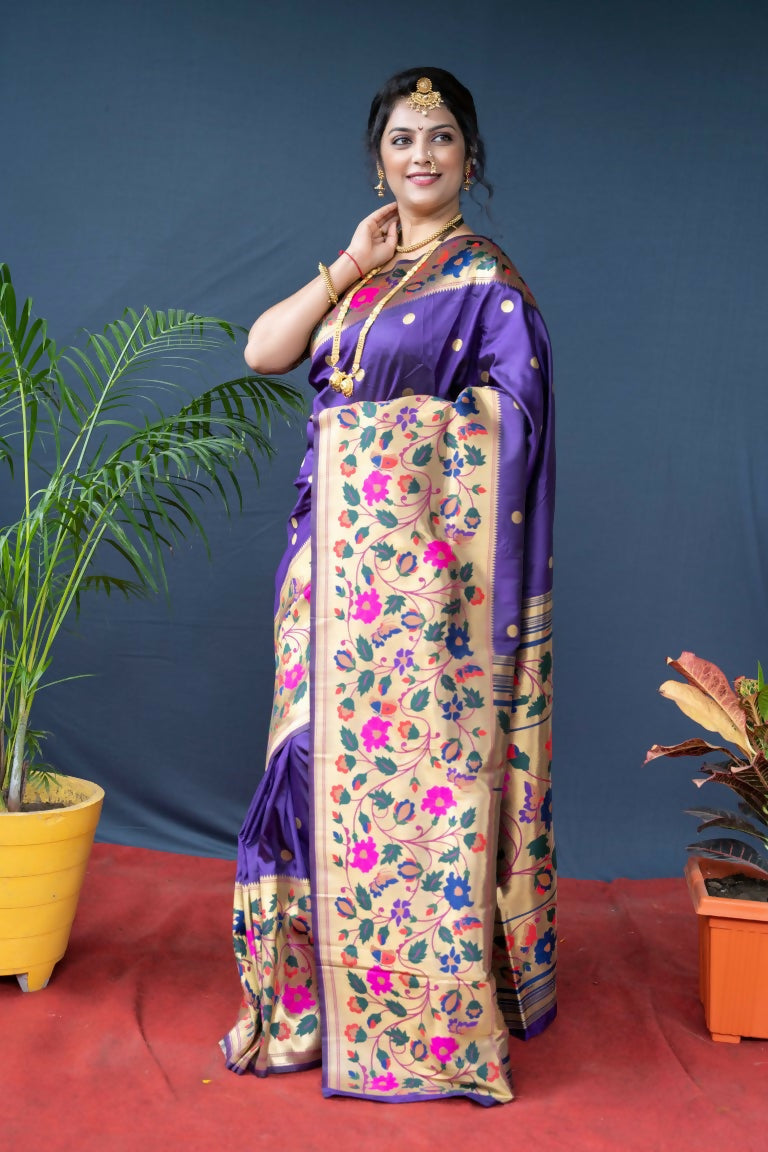 Close up of a deep purple Paithani silk saree showing the fine Zari woven craftsmanship and elegant drape.
