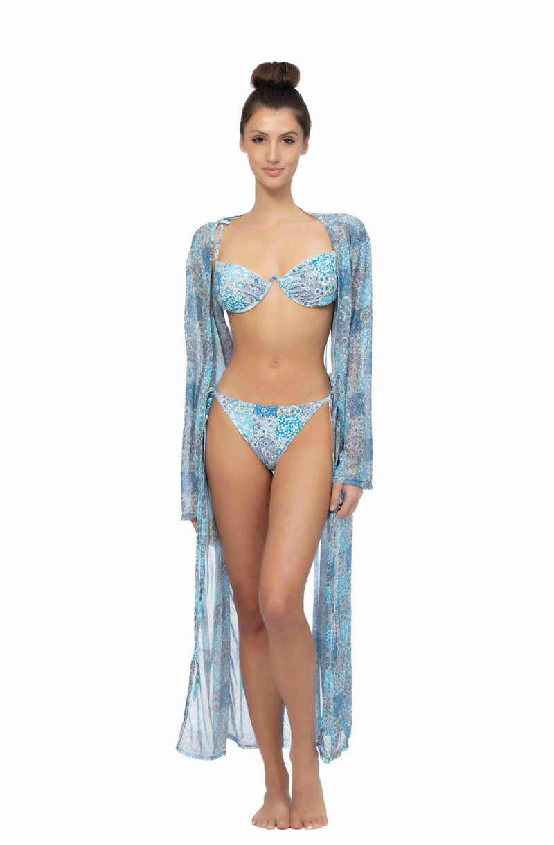 Model wearing a long sleeve, patchwork print mesh maxi kimono cover up with front tie closure at the beach.