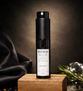 Sleek black 8mL Roma Noir travel perfume atomizer on a minimalist background