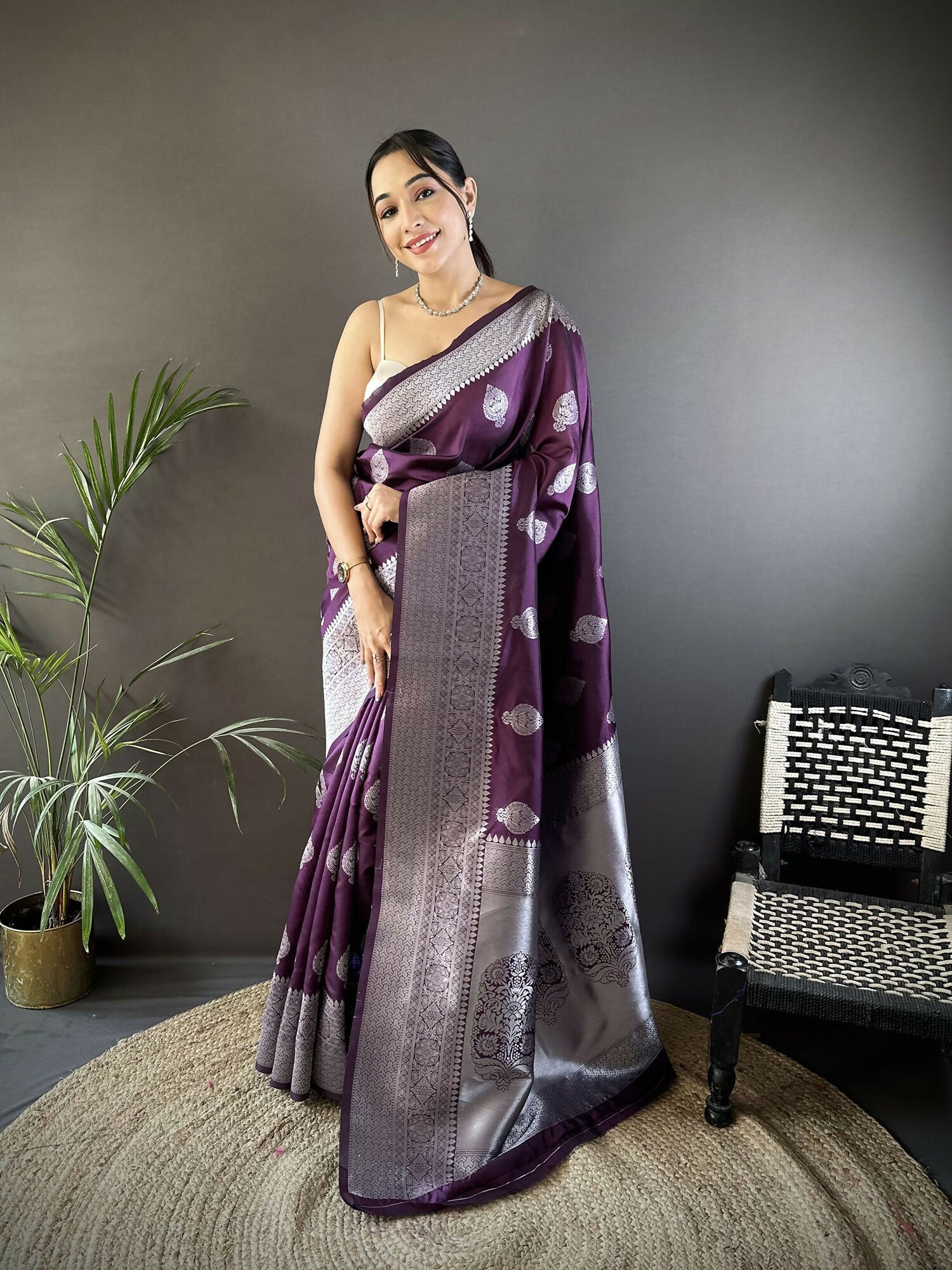 Wine colored soft silk Banarasi saree with intricate floral motif detailing