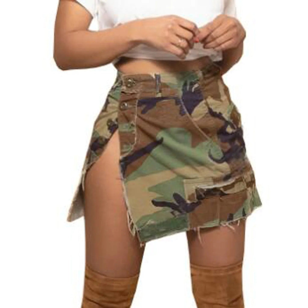 A woman wearing a trendy camouflage mini skirt with an asymmetrical hem, side button closure, and cargo pockets, styled with a white top and brown boots.