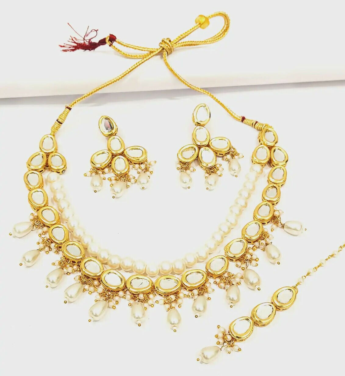 Traditional gold-plated Kundan jewellery set with intricate stone work
