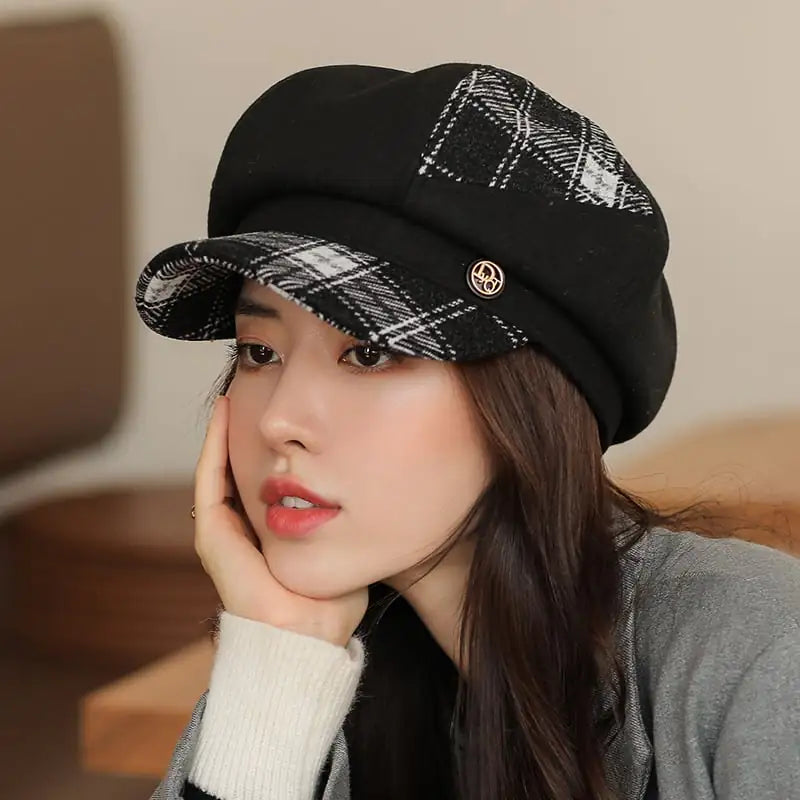 A woman wearing a black and white plaid octagonal newsboy cap during winter.