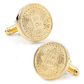 A pair of round gold-tone cufflinks featuring a debossed Bitcoin logo design on a white background.