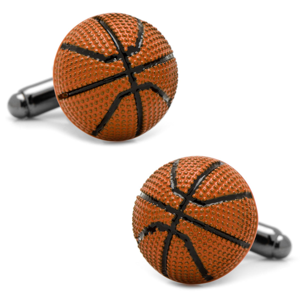 Close up of a pair of 3D basketball cufflinks with orange textured enamel and black lines on a silver-tone metal backing.