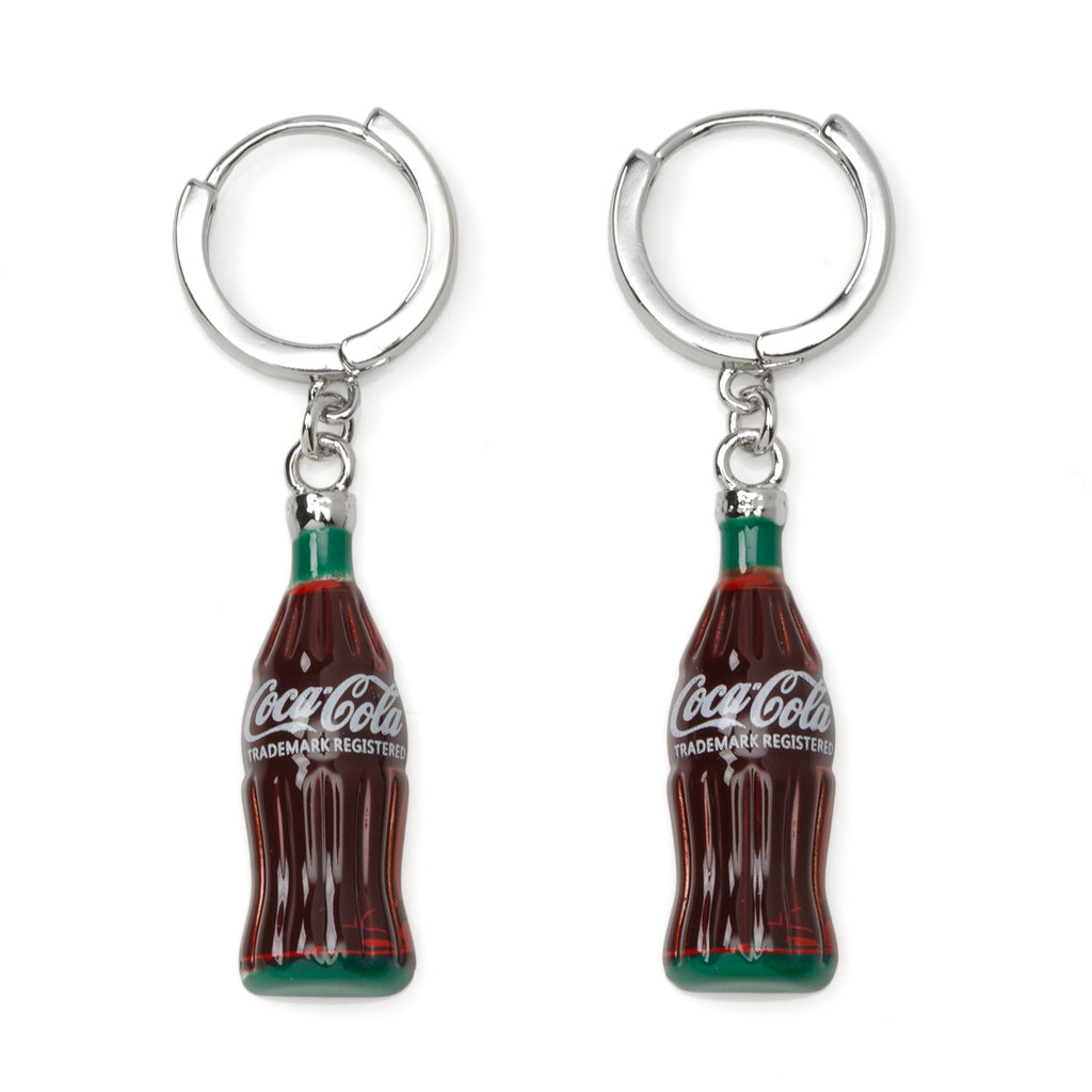 A pair of Coca-Cola glass bottle dangle earrings featuring silver-tone hoop closures on a white background.